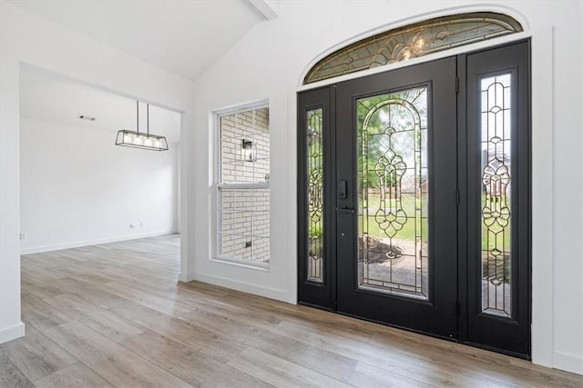 119 Elm St, Centerton, AR 72719 - foyer with vaulted ceiling, wood finished floors, and baseboards