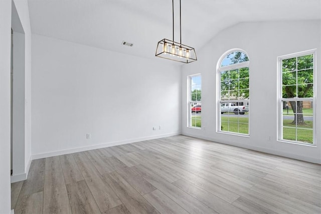 119 Elm St, Centerton, AR 72719 - unfurnished dining area with wood finished floors, lofted ceiling, a chandelier, and baseboards