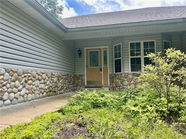 37 Retford Dr, Bella Vista, AR 72715 - doorway to property featuring a shingled roof and stone siding