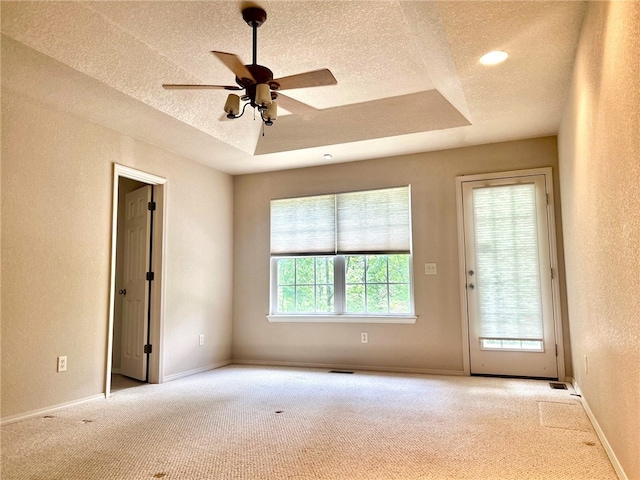 37 Retford Dr, Bella Vista, AR 72715 - carpeted spare room featuring a textured ceiling, ceiling fan, a textured wall, baseboards, and a tray ceiling