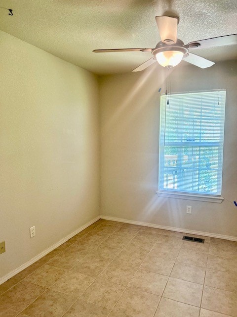 37 Retford Dr, Bella Vista, AR 72715 - spare room featuring light tile patterned floors, a textured ceiling, and ceiling fan