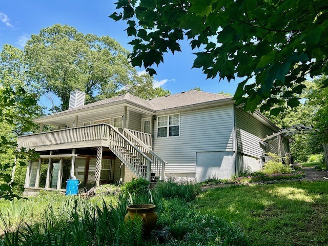 37 Retford Dr, Bella Vista, AR 72715 - rear view of property with a chimney, a deck, and stairway