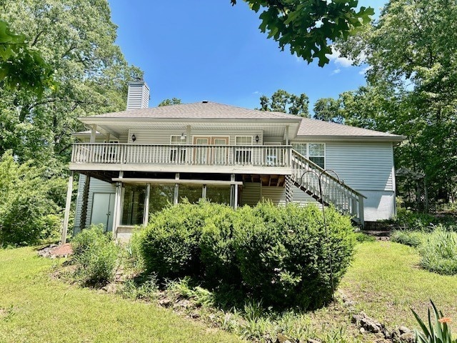 37 Retford Dr, Bella Vista, AR 72715 - back of house featuring stairway, a wooden deck, a chimney, and a lawn