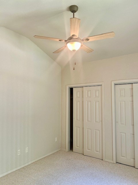 37 Retford Dr, Bella Vista, AR 72715 - unfurnished bedroom featuring carpet, multiple closets, a ceiling fan, and vaulted ceiling