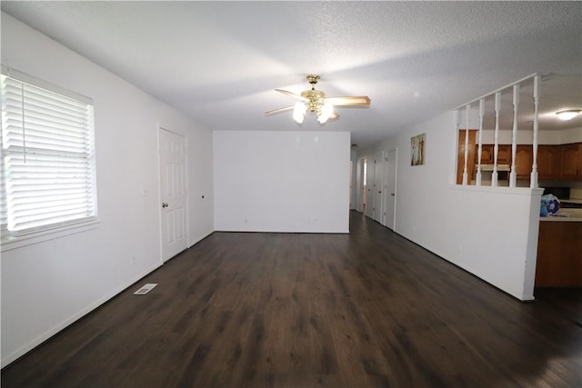 3064 Brandy Ln, Springdale, AR 72762 - unfurnished room featuring dark wood-style floors, a ceiling fan, and baseboards