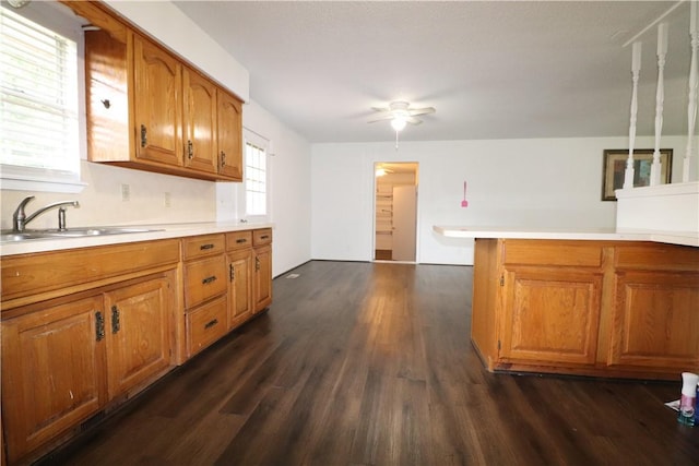 3064 Brandy Ln, Springdale, AR 72762 - kitchen featuring dark wood finished floors, brown cabinetry, a sink, ceiling fan, and light countertops