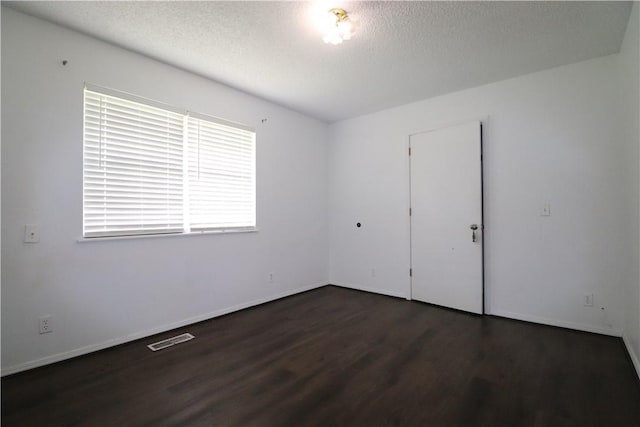 3064 Brandy Ln, Springdale, AR 72762 - unfurnished room with wood finished floors, a textured ceiling, and baseboards