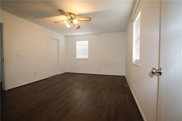 3064 Brandy Ln, Springdale, AR 72762 - empty room featuring dark wood-style flooring, a ceiling fan, and baseboards