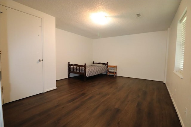 3064 Brandy Ln, Springdale, AR 72762 - unfurnished bedroom featuring wood finished floors and a textured ceiling
