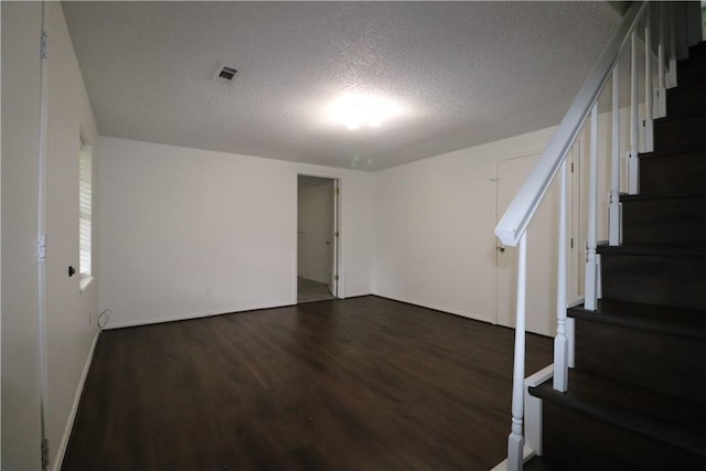 3064 Brandy Ln, Springdale, AR 72762 - basement featuring stairway, a textured ceiling, and dark wood-style flooring