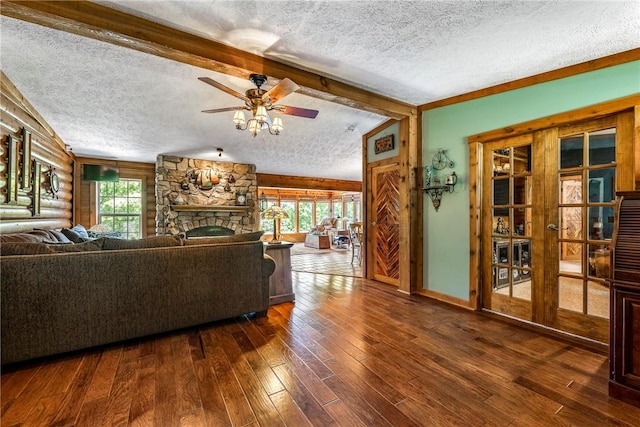 2895 County Road 116, Eureka Springs, AR 72631 - living room featuring healthy amount of natural light, a textured ceiling, ceiling fan, wood-type flooring, and a fireplace