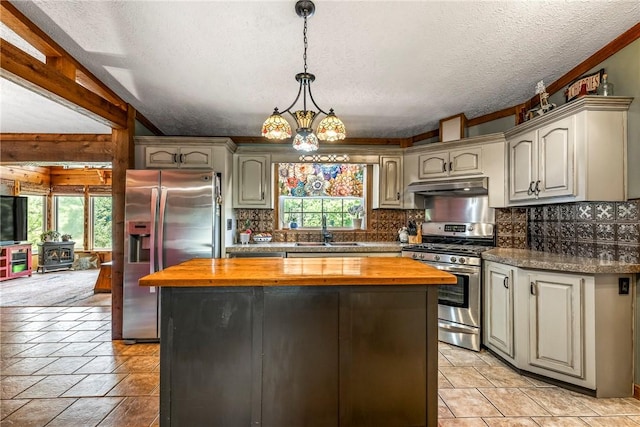 2895 County Road 116, Eureka Springs, AR 72631 - kitchen featuring stainless steel appliances, butcher block countertops, under cabinet range hood, healthy amount of natural light, and a textured ceiling