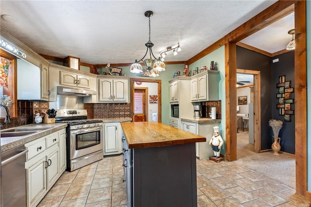 2895 County Road 116, Eureka Springs, AR 72631 - kitchen featuring stainless steel appliances, wood counters, under cabinet range hood, backsplash, and a kitchen island