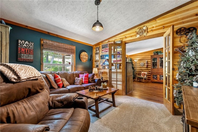 2895 County Road 116, Eureka Springs, AR 72631 - living room with vaulted ceiling, french doors, a textured ceiling, wood finished floors, and carpet