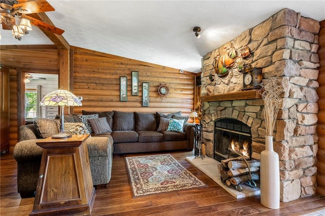 2895 County Road 116, Eureka Springs, AR 72631 - living area with log walls, a fireplace, a ceiling fan, wood-type flooring, and vaulted ceiling