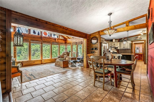 2895 County Road 116, Eureka Springs, AR 72631 - dining area featuring vaulted ceiling, a textured ceiling, and wood walls