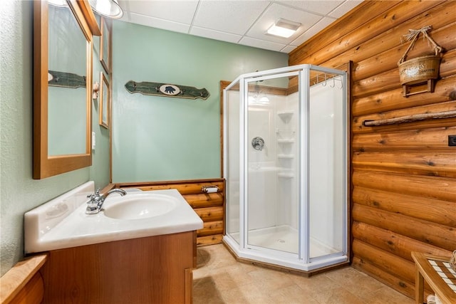 2895 County Road 116, Eureka Springs, AR 72631 - bathroom with rustic walls, vanity, a shower stall, and a drop ceiling