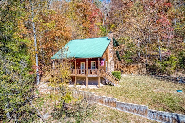 96NC6450 457 NC-6012, Jasper, AR 72641 - view of front of property with stairway, a chimney, a front lawn, a wooded view, and metal roof