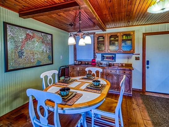 96NC6450 457 NC-6012, Jasper, AR 72641 - dining room with wood ceiling with exposed beams, dark wood finished floors, wooden walls, and baseboards