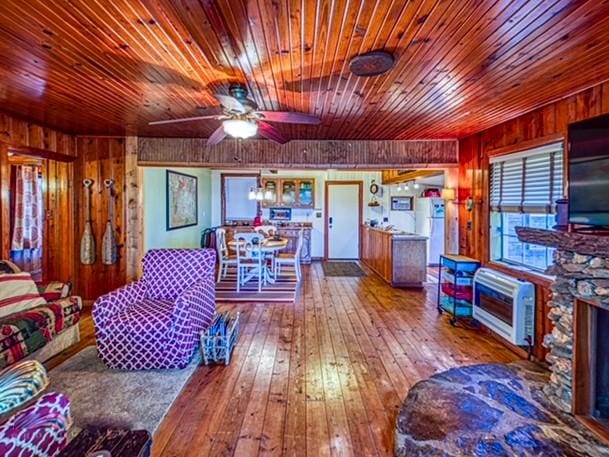 96NC6450 457 NC-6012, Jasper, AR 72641 - living area with wooden walls, ceiling fan, hardwood / wood-style flooring, a fireplace, and wooden ceiling