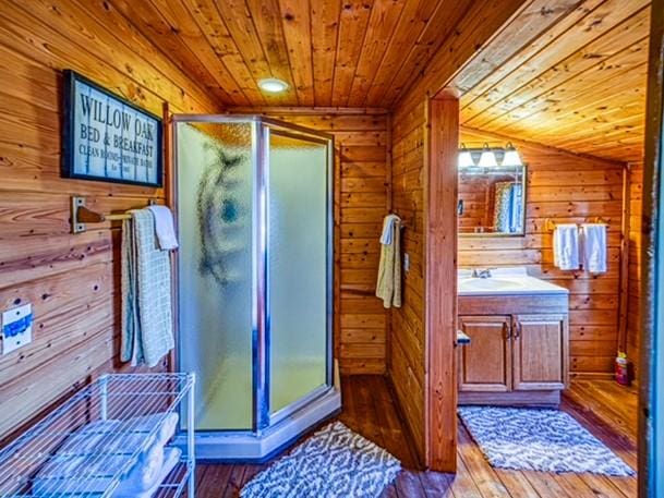 96NC6450 457 NC-6012, Jasper, AR 72641 - full bathroom featuring wood ceiling, vanity, wood walls, hardwood / wood-style flooring, and a stall shower