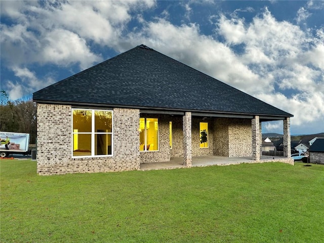 2822 N Grey Squirrel Dr, Fayetteville, AR 72704 - back of house featuring brick siding, a patio, a shingled roof, and a lawn