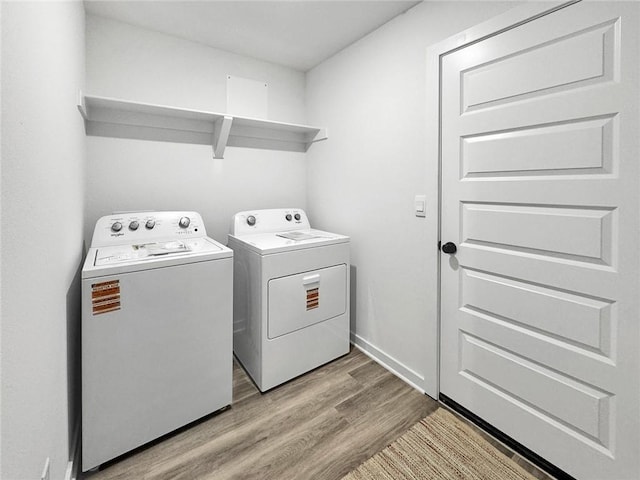 2822 N Grey Squirrel Dr, Fayetteville, AR 72704 - laundry area featuring washing machine and dryer and light wood-type flooring