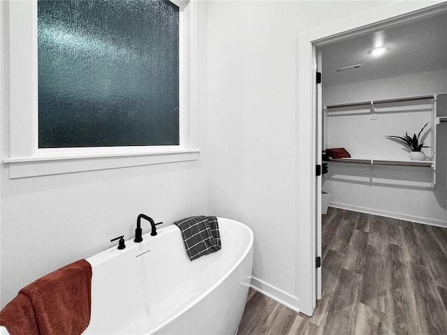 2822 N Grey Squirrel Dr, Fayetteville, AR 72704 - bathroom featuring a soaking tub, wood finished floors, and baseboards