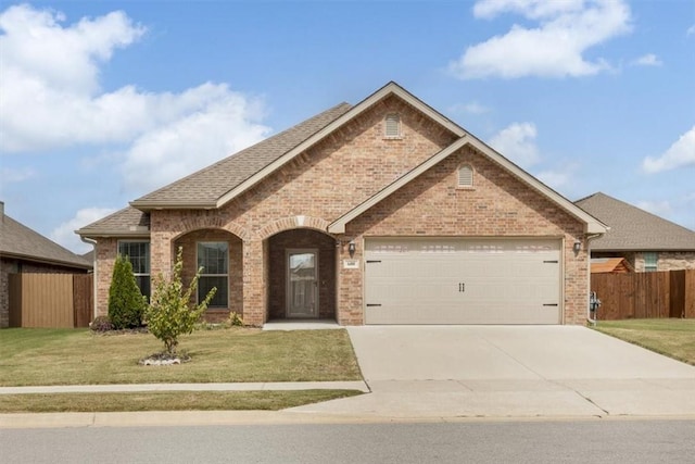 600 Gala Cir, Bentonville, AR 72712 - view of front of property featuring brick siding, driveway, an attached garage, and a shingled roof