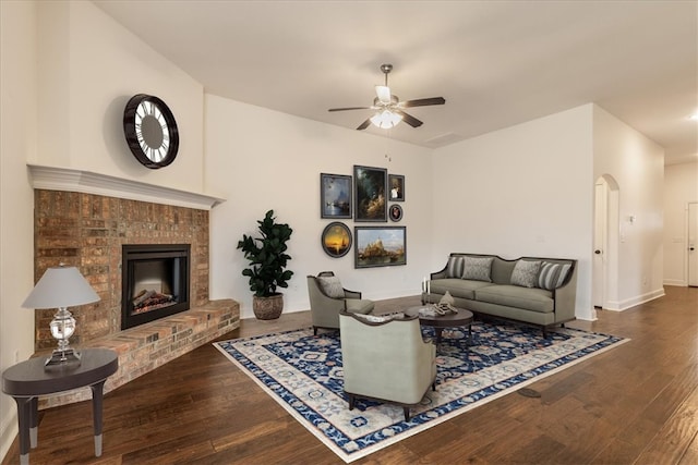 600 Gala Cir, Bentonville, AR 72712 - living area featuring ceiling fan, hardwood / wood-style floors, a brick fireplace, and baseboards