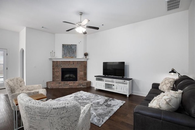 600 Gala Cir, Bentonville, AR 72712 - living area featuring ceiling fan, wood finished floors, a fireplace, baseboards, and arched walkways
