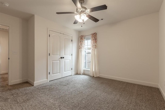 600 Gala Cir, Bentonville, AR 72712 - unfurnished bedroom with carpet flooring, baseboards, a closet, and ceiling fan
