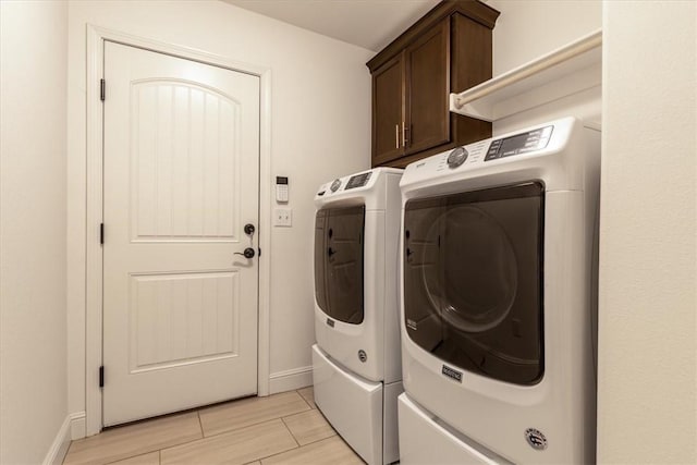 600 Gala Cir, Bentonville, AR 72712 - laundry area featuring separate washer and dryer, cabinet space, baseboards, and wood finish floors