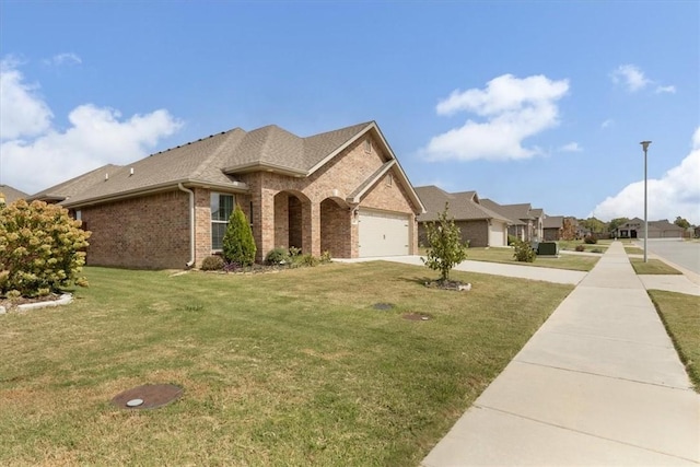 600 Gala Cir, Bentonville, AR 72712 - view of front of home with brick siding, a garage, concrete driveway, a front lawn, and a shingled roof