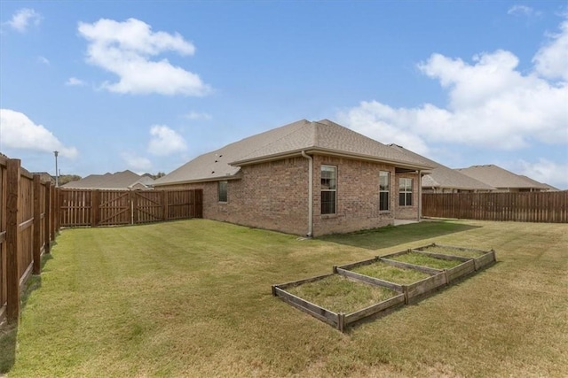 600 Gala Cir, Bentonville, AR 72712 - rear view of house featuring a garden and brick siding