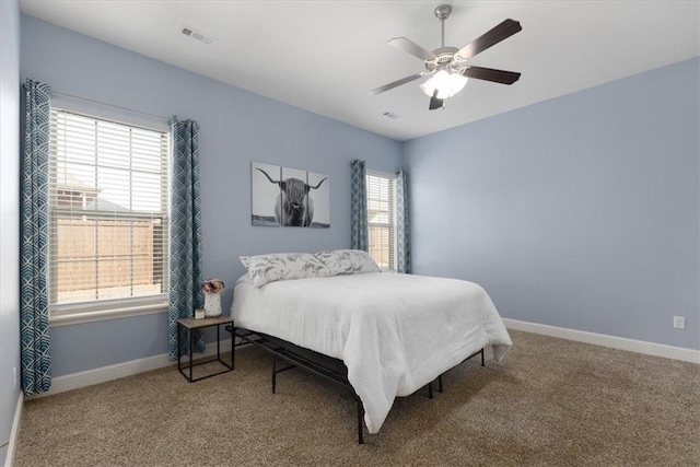 600 Gala Cir, Bentonville, AR 72712 - carpeted bedroom featuring multiple windows, baseboards, and a ceiling fan