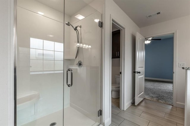 600 Gala Cir, Bentonville, AR 72712 - full bathroom with a stall shower, toilet, baseboards, and ceiling fan