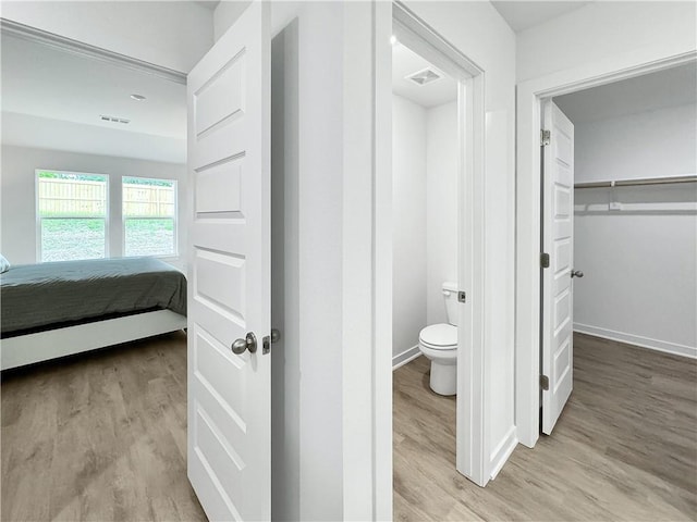 1661 Ridgeview Dr, Springdale, AR 72762 - bathroom featuring toilet, wood finished floors, and baseboards