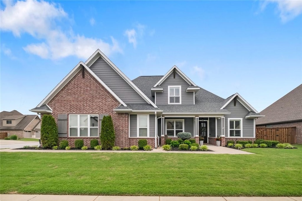 8604 W Birdsong Ln, Bentonville, AR 72713 - craftsman house with brick siding and a shingled roof