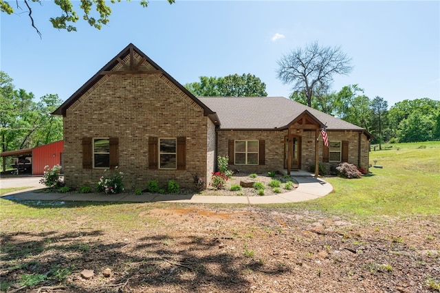 480124 E 1082nd Rd, Muldrow, OK 74948 - view of front facade with a front yard, brick siding, and a carport