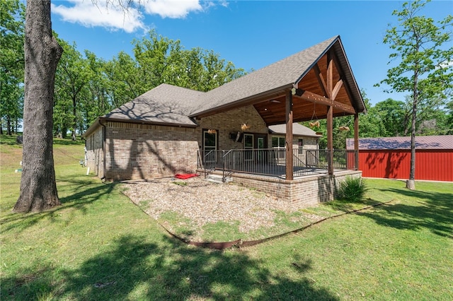 480124 E 1082nd Rd, Muldrow, OK 74948 - back of house with brick siding, a lawn, roof with shingles, and a patio