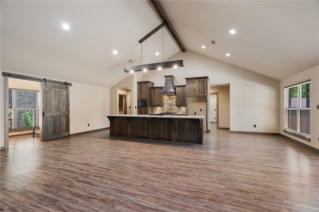 480124 E 1082nd Rd, Muldrow, OK 74948 - kitchen featuring dark wood-style flooring, a barn door, dark brown cabinetry, beam ceiling, and light countertops
