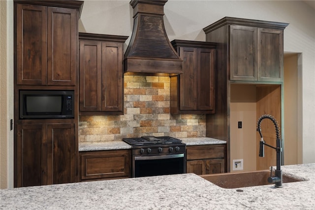 480124 E 1082nd Rd, Muldrow, OK 74948 - kitchen with black range with gas stovetop, built in microwave, premium range hood, and decorative backsplash