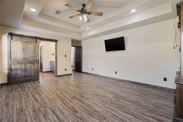 480124 E 1082nd Rd, Muldrow, OK 74948 - unfurnished living room with wood finished floors, a tray ceiling, a ceiling fan, baseboards, and recessed lighting