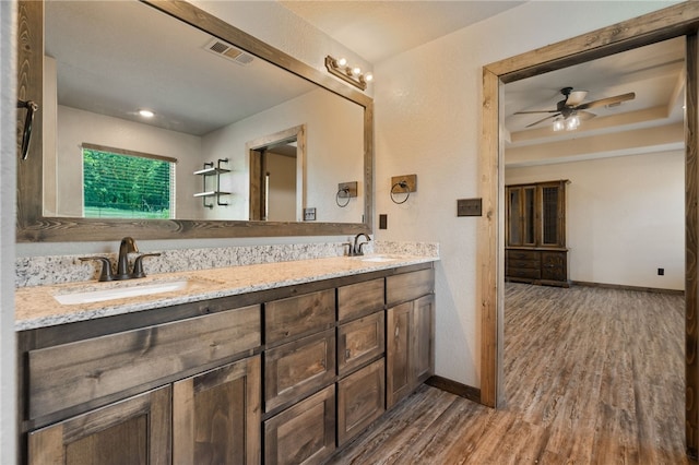480124 E 1082nd Rd, Muldrow, OK 74948 - full bathroom with wood finished floors, double vanity, a ceiling fan, and baseboards