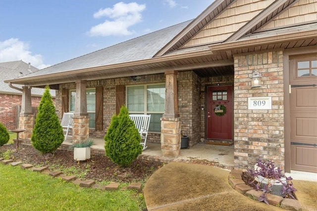 809 Dollar St, Cave Springs, AR 72718 - doorway to property featuring covered porch and brick siding
