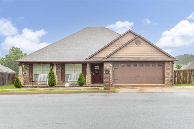 809 Dollar St, Cave Springs, AR 72718 - view of front facade featuring an attached garage, driveway, brick siding, and a porch
