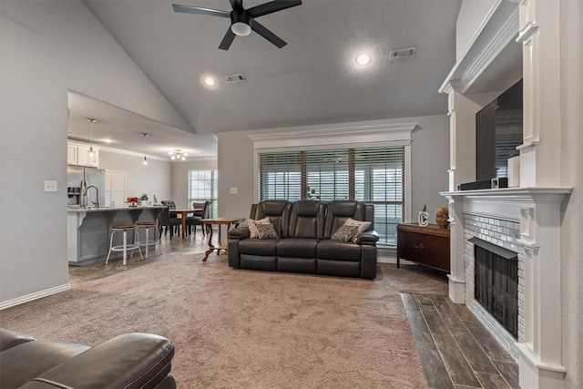 809 Dollar St, Cave Springs, AR 72718 - living area with ceiling fan, lofted ceiling, a tile fireplace, recessed lighting, and baseboards
