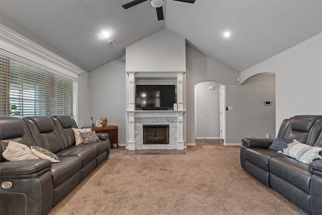 809 Dollar St, Cave Springs, AR 72718 - living area featuring arched walkways, a ceiling fan, light carpet, a tile fireplace, and high vaulted ceiling