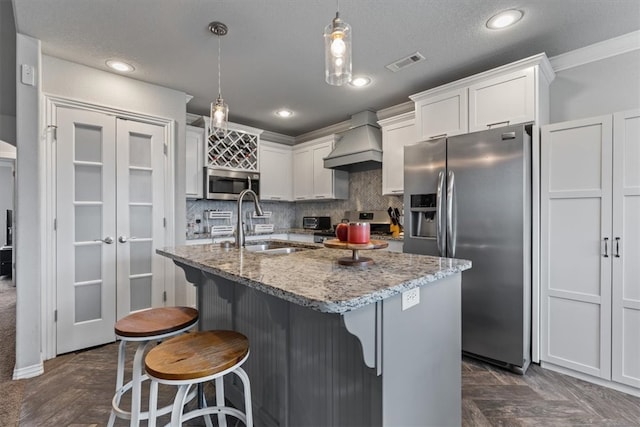 809 Dollar St, Cave Springs, AR 72718 - kitchen featuring custom exhaust hood, stainless steel appliances, a sink, tasteful backsplash, and white cabinetry